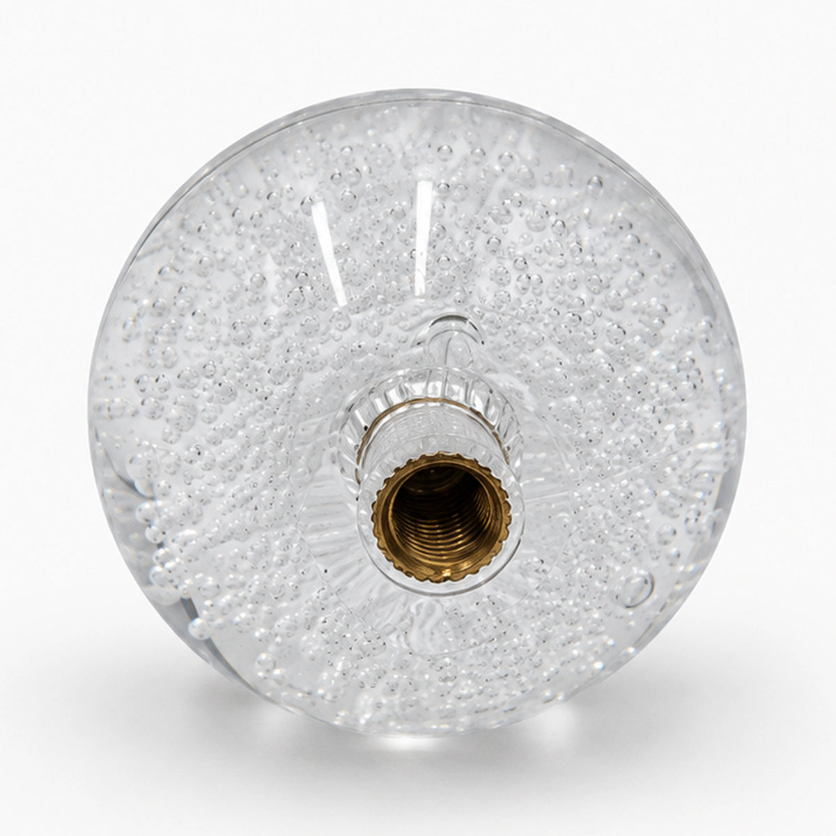 Clear arcade joystick ball with internal air bubbles and a brass-colored mounting insert.