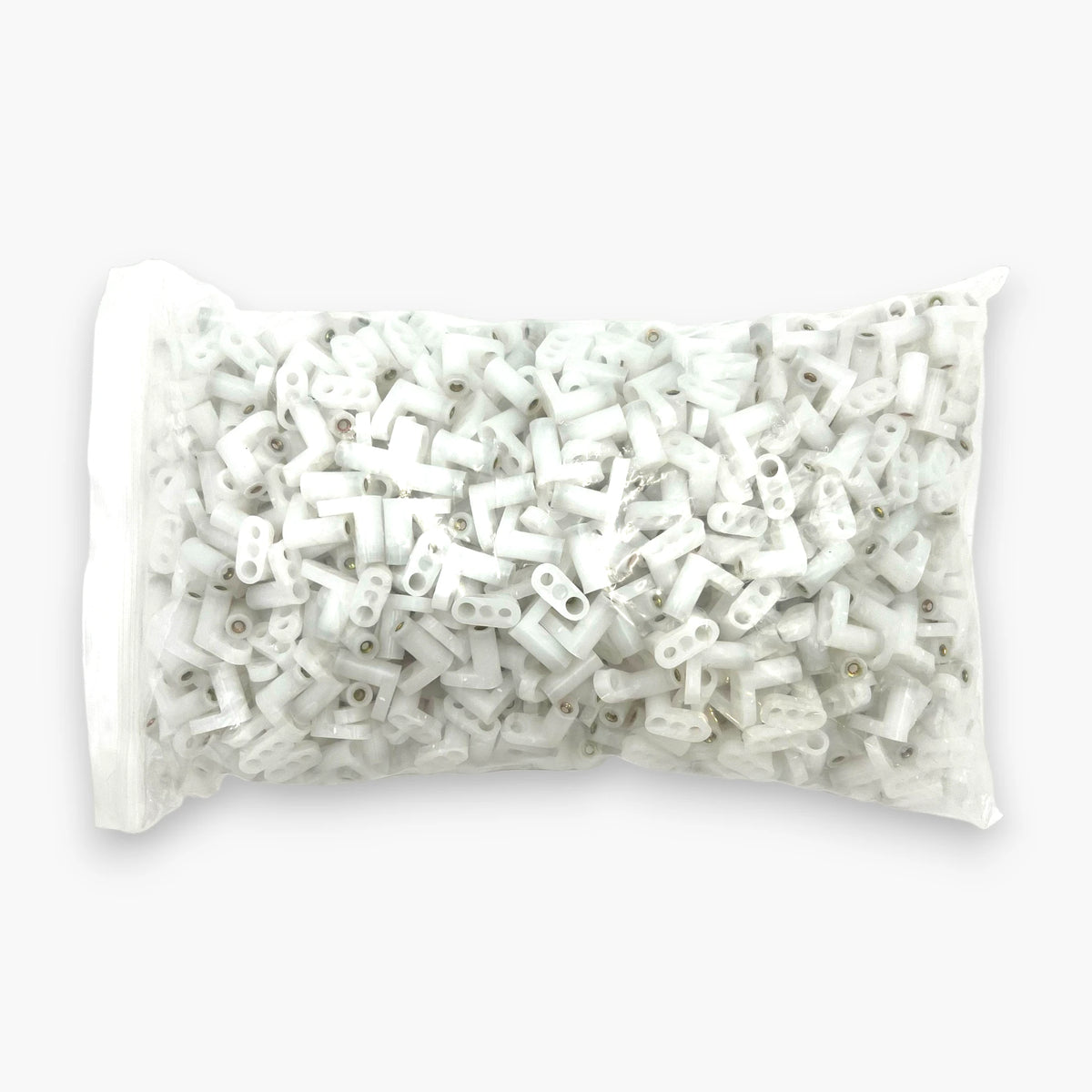 Bulk bag of 1000 white L-shaped PCB mounting feet for arcade game boards