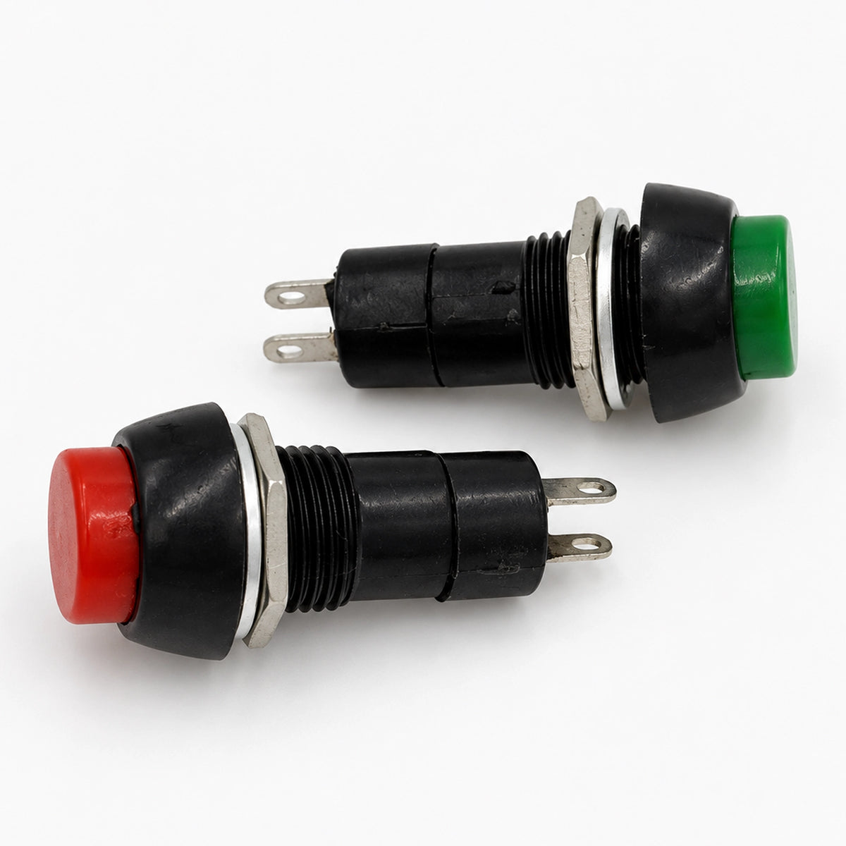 Red and green PBS-11B push-button switches with threaded black bodies, metal mounting nuts, and two terminals.

