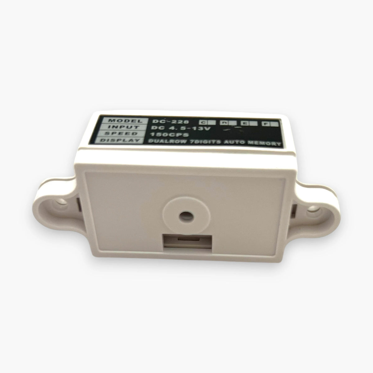 Back of DOTCOM DC-228 LCD counter showing connector port and screw mounting tabs