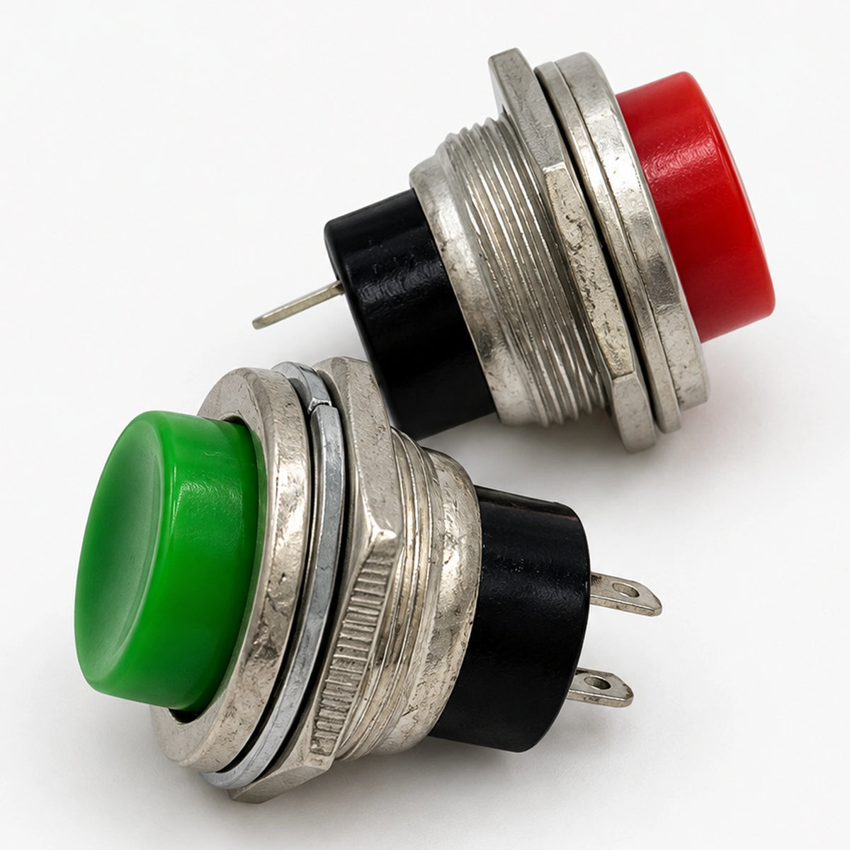 Angled view of red and green PS-212 switches showing threaded bodies and black terminal bases.